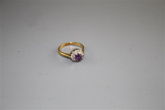 A modern 18ct gold, amethyst and diamond set circular cluster ring, size I, gross weight 3.2 grams.